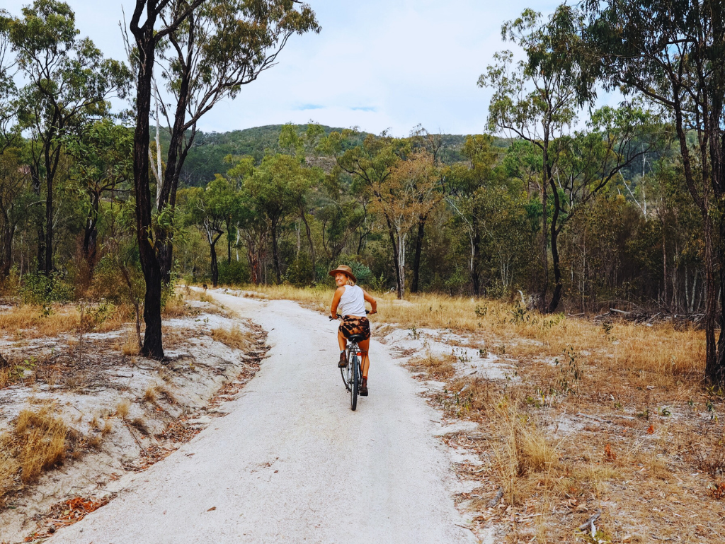 A camper taking a stroll at a campsite in Childers using a bike.